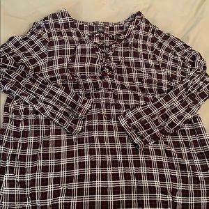 Flannel patterned blouse with lace up neck line.